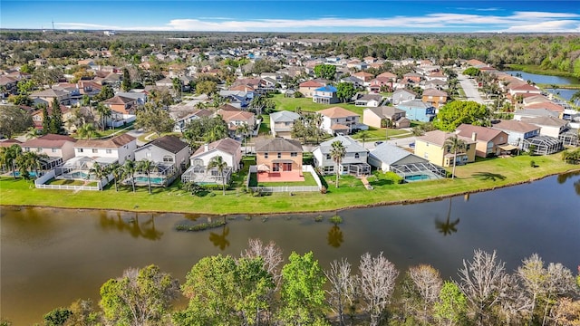 bird's eye view featuring a water view and a residential view