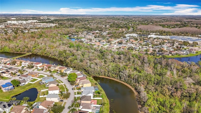 drone / aerial view with a water view and a residential view