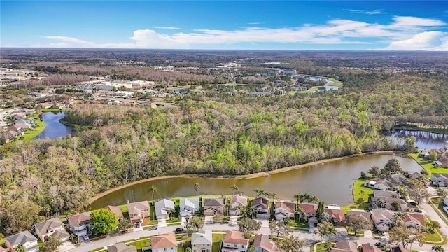 drone / aerial view featuring a residential view, a water view, and a forest view