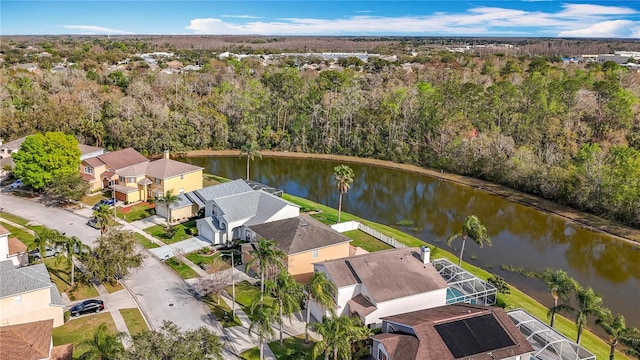 birds eye view of property featuring a water view, a residential view, and a view of trees