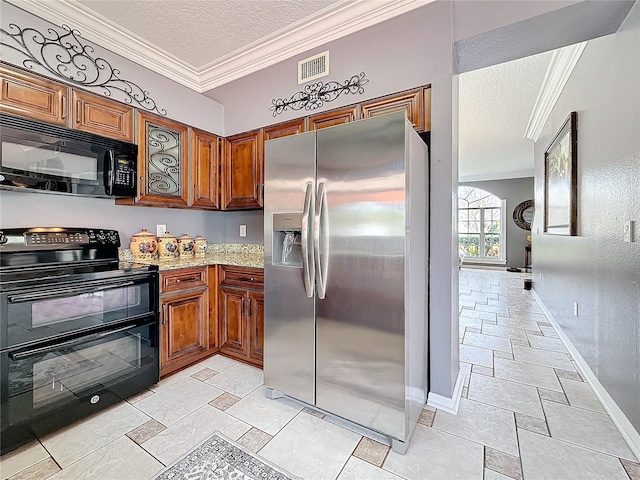kitchen with visible vents, crown molding, baseboards, a textured ceiling, and black appliances