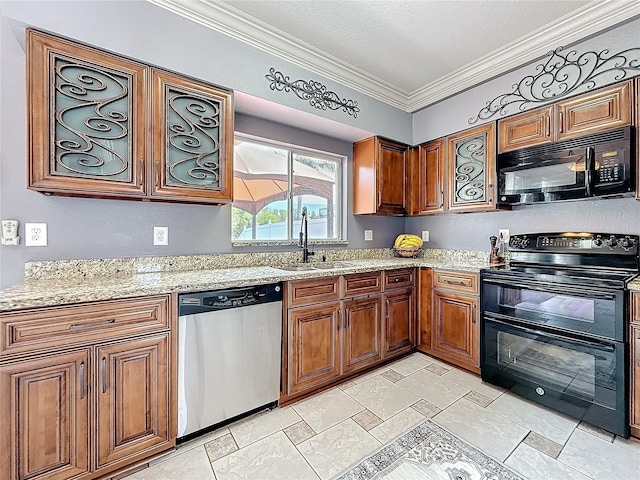 kitchen with brown cabinets, a sink, light stone counters, black appliances, and ornamental molding