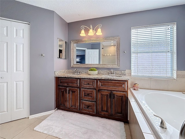 full bathroom with double vanity, tile patterned floors, a sink, and a bath