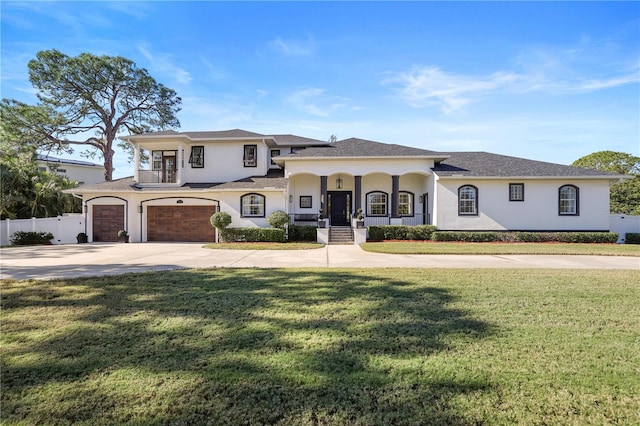 view of front facade featuring a garage, a front yard, and a porch