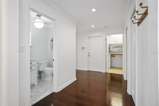 corridor with dark wood-type flooring and ornamental molding