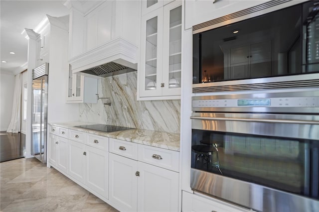 kitchen with decorative backsplash, light stone countertops, stainless steel appliances, ornamental molding, and white cabinets