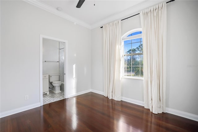 unfurnished bedroom with ceiling fan, crown molding, dark hardwood / wood-style floors, and ensuite bath