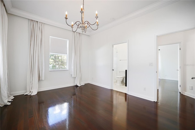 unfurnished room featuring dark hardwood / wood-style floors, an inviting chandelier, and ornamental molding