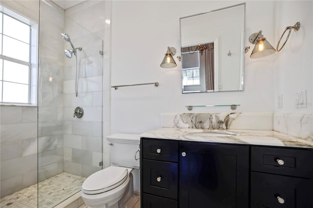 bathroom with toilet, an enclosed shower, and vanity