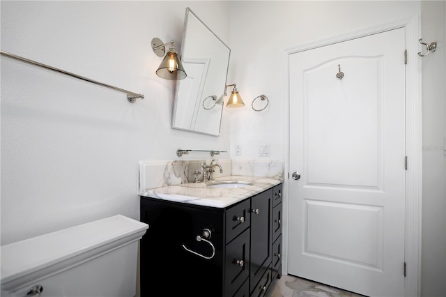 bathroom featuring toilet and vanity