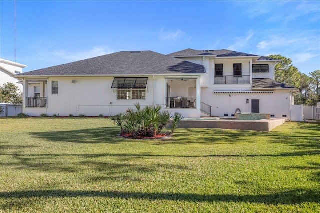 rear view of property with a yard