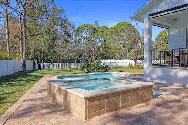 view of swimming pool with an in ground hot tub, a yard, and a patio