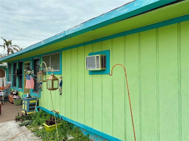 view of property exterior with a wall mounted air conditioner