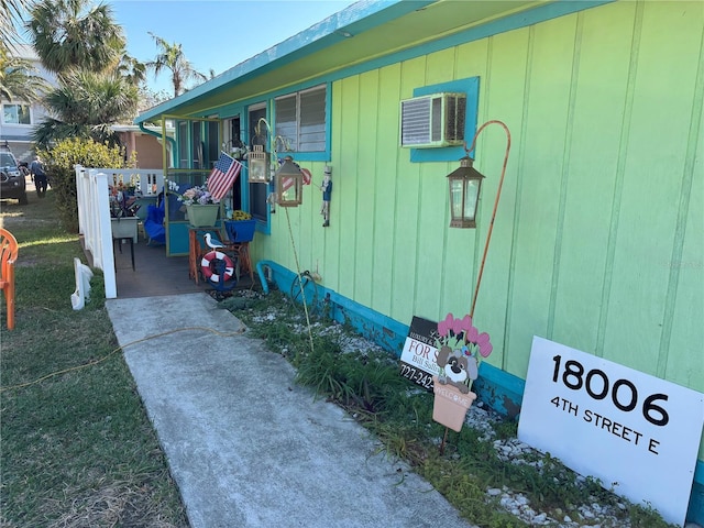 view of side of property featuring a wall mounted AC