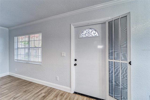 entryway with crown molding and hardwood / wood-style flooring