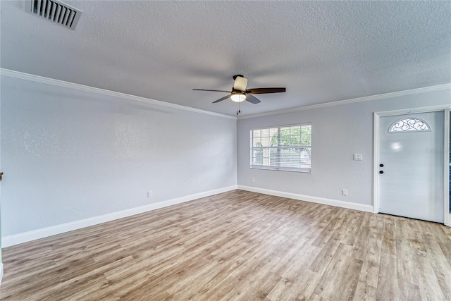 interior space featuring a textured ceiling, ceiling fan, ornamental molding, and light hardwood / wood-style flooring