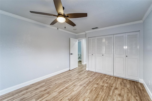 unfurnished bedroom with a closet, ceiling fan, light hardwood / wood-style floors, and ornamental molding