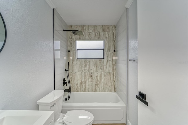 bathroom with toilet and tiled shower / bath