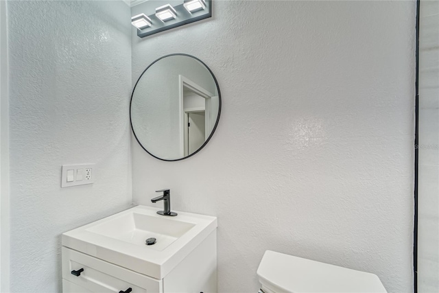 bathroom with toilet and vanity