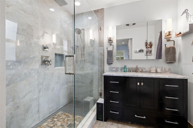 bathroom with vanity, an enclosed shower, and hardwood / wood-style floors