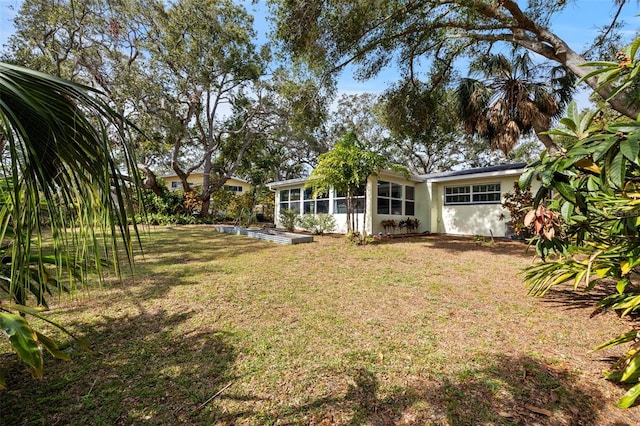 view of yard featuring a sunroom