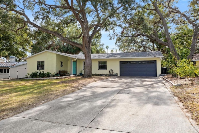 ranch-style home with a garage and a front yard