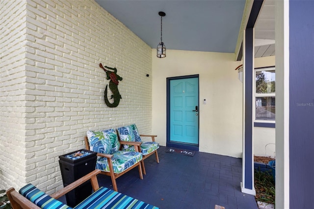 property entrance with stucco siding and brick siding