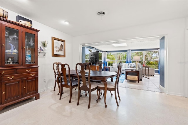 dining room with a healthy amount of sunlight, baseboards, and visible vents