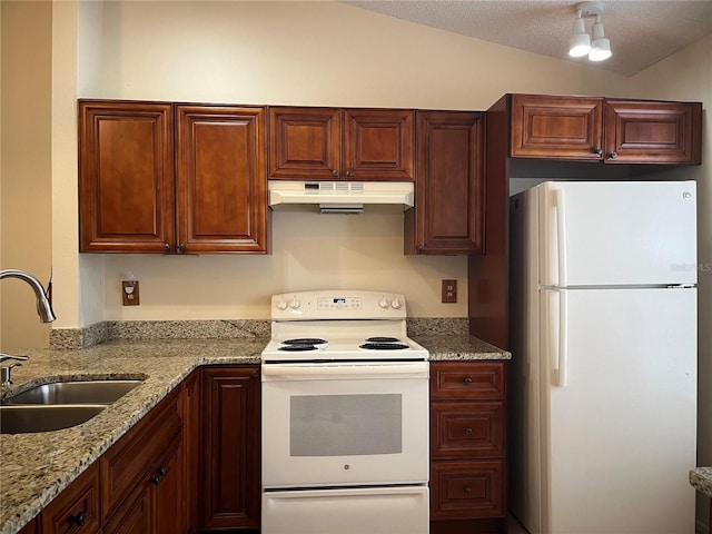 kitchen featuring light stone countertops, white appliances, a textured ceiling, sink, and vaulted ceiling