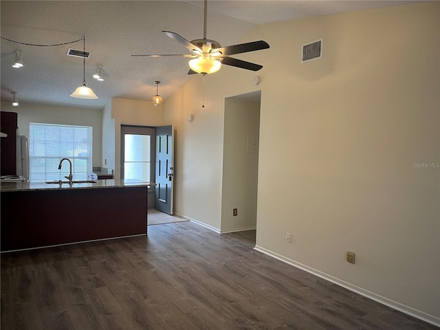 kitchen featuring dark hardwood / wood-style flooring, sink, hanging light fixtures, vaulted ceiling, and ceiling fan