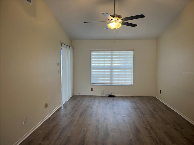 empty room featuring ceiling fan, dark wood-type flooring, and vaulted ceiling