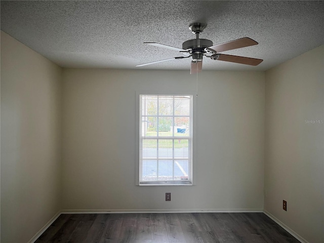 spare room with ceiling fan, dark wood-type flooring, and a textured ceiling