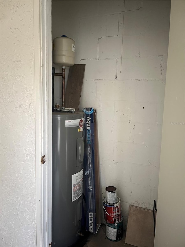 utility room featuring electric water heater