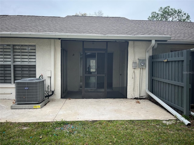 view of exterior entry featuring a patio area and cooling unit