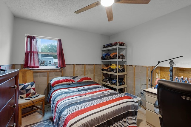 bedroom with a textured ceiling and ceiling fan