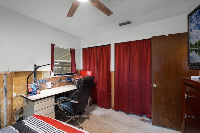 home office featuring a textured ceiling and ceiling fan