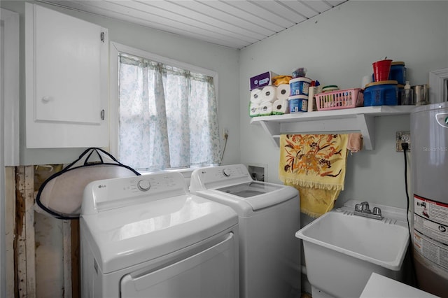 washroom featuring water heater, separate washer and dryer, and sink