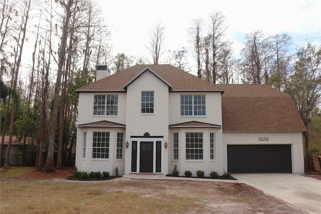 view of front of house featuring a garage and a front lawn