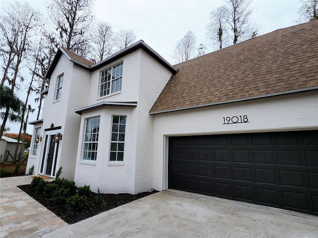 view of side of property with a garage