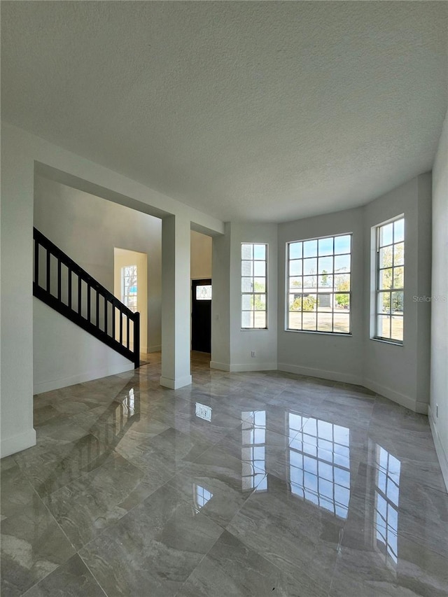 unfurnished living room with a textured ceiling