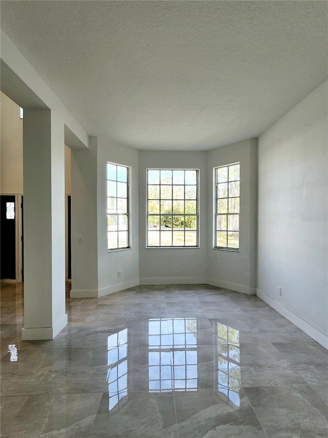 spare room featuring a textured ceiling