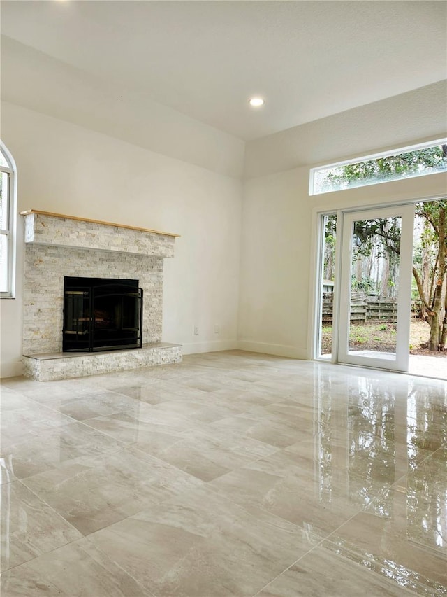 unfurnished living room with a stone fireplace