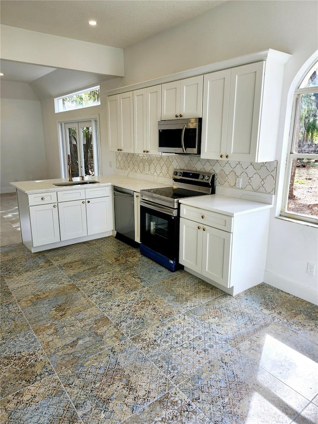 kitchen featuring white cabinets, backsplash, sink, and stainless steel appliances