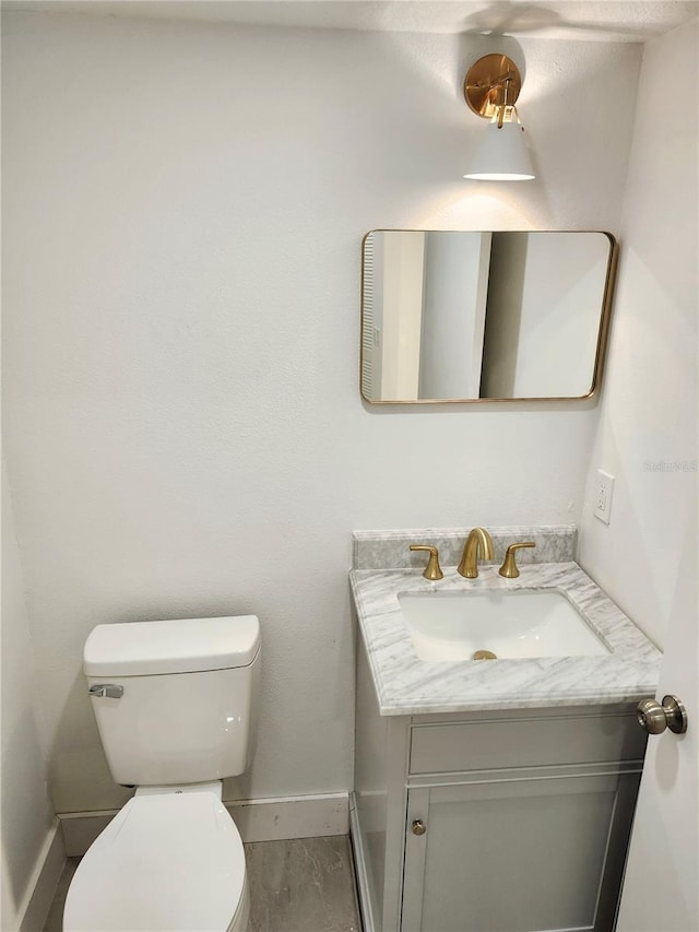 bathroom with toilet and vanity