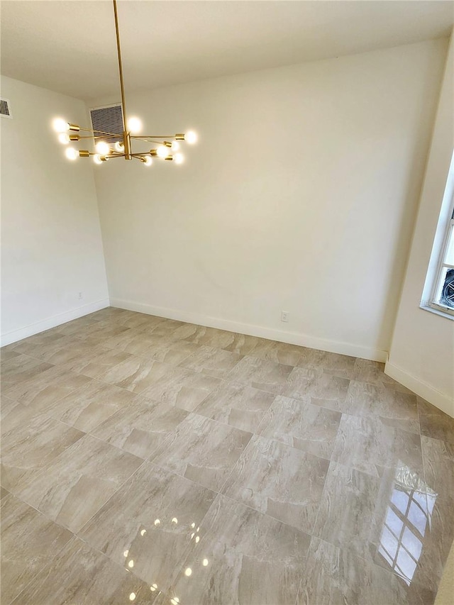 unfurnished room featuring visible vents, baseboards, and an inviting chandelier