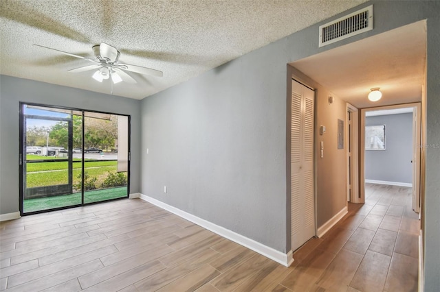 spare room featuring ceiling fan and light wood-type flooring