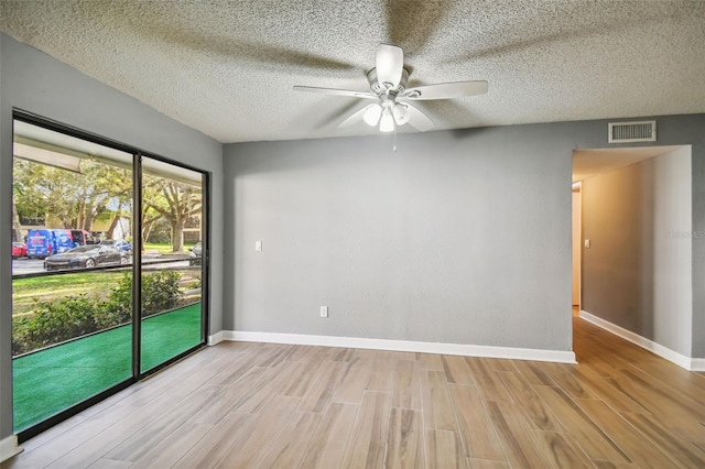 unfurnished room with a textured ceiling, ceiling fan, and light hardwood / wood-style floors