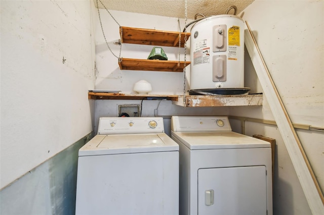 clothes washing area featuring water heater and separate washer and dryer