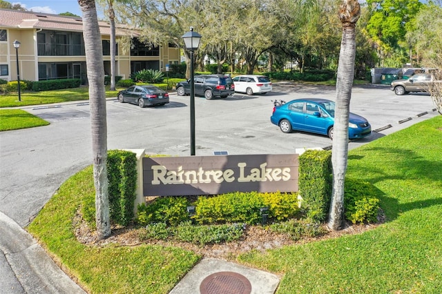 community sign featuring a lawn