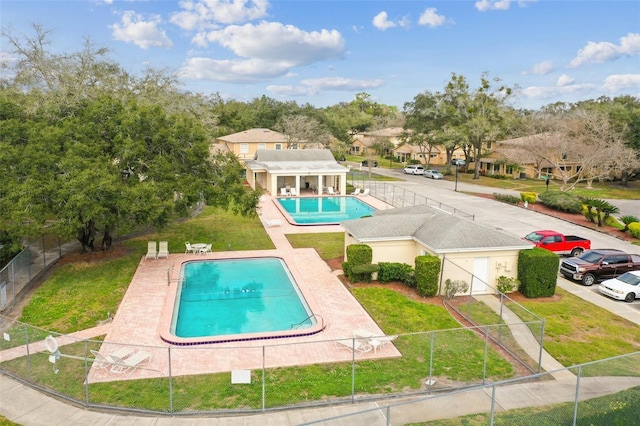 view of pool with a yard, an outbuilding, and a patio